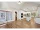 Open concept kitchen with stainless steel appliances, granite countertops, and wood floors, leading into the dining area at 1431 Brandy Shoals Se Ct, Conyers, GA 30013