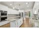 Spacious kitchen featuring stainless steel appliances, granite countertops, an island cooktop, and ample cabinet space at 1431 Brandy Shoals Se Ct, Conyers, GA 30013