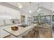 Bright, open kitchen featuring a large island with granite countertops and a dining area with backyard views at 1431 Brandy Shoals Se Ct, Conyers, GA 30013