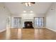 Living room showcasing a fireplace, vaulted ceiling, and wood floors offering comfort and style for gatherings and relaxation at 1431 Brandy Shoals Se Ct, Conyers, GA 30013