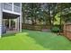 Lush backyard with a well-maintained lawn, patio area, and privacy fence at 1904 Woodland Hills Nw Ave, Atlanta, GA 30318