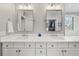 Bright bathroom featuring double sinks, quartz countertops, modern fixtures, and custom cabinets at 1904 Woodland Hills Nw Ave, Atlanta, GA 30318