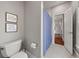 Well-lit bathroom with tile floors, toilet, and framed inspirational quotes at 1904 Woodland Hills Nw Ave, Atlanta, GA 30318