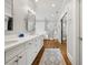Bright bathroom with dual sinks, white cabinetry, and a glass-enclosed shower at 1904 Woodland Hills Nw Ave, Atlanta, GA 30318