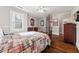 Bright bedroom featuring hardwood floors and a decorative bed with a colorful, patterned comforter at 1904 Woodland Hills Nw Ave, Atlanta, GA 30318