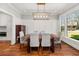 Bright dining room with large windows, hardwood floors, and modern lighting at 1904 Woodland Hills Nw Ave, Atlanta, GA 30318