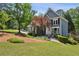 Charming two-story home with blue siding, manicured lawn, and inviting front entrance at 1904 Woodland Hills Nw Ave, Atlanta, GA 30318