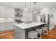 Modern kitchen with white cabinets, stainless steel appliances, and a center island at 1904 Woodland Hills Nw Ave, Atlanta, GA 30318