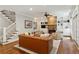 Spacious living room with a stone fireplace, built-in shelves, and hardwood floors at 1904 Woodland Hills Nw Ave, Atlanta, GA 30318