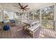 Inviting screened porch with wooden floors and beams featuring comfortable seating and dining areas at 1904 Woodland Hills Nw Ave, Atlanta, GA 30318