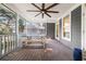 Inviting screened porch with wooden floors and beams featuring comfortable seating and dining areas at 1904 Woodland Hills Nw Ave, Atlanta, GA 30318