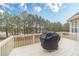 View of the back deck featuring a grill and overlooking mature trees at 3365 Preservation Cir, Lilburn, GA 30047