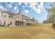 Extensive backyard with a well-maintained lawn and views of the home's deck and sunroom at 3365 Preservation Cir, Lilburn, GA 30047