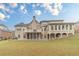Expansive backyard featuring a multi-story home with a deck and sunroom at 3365 Preservation Cir, Lilburn, GA 30047