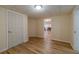 Finished basement hallway with hardwood floors and view into main room at 3365 Preservation Cir, Lilburn, GA 30047