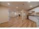 Open basement area with a kitchenette, wood floors, recessed lighting, and versatile layout at 3365 Preservation Cir, Lilburn, GA 30047