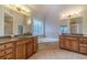 Spacious bathroom with dual vanities, a soaking tub, and decorative window at 3365 Preservation Cir, Lilburn, GA 30047