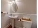 Powder room with pedestal sink, toilet, and paneled walls at 3365 Preservation Cir, Lilburn, GA 30047