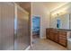 Well-lit bathroom with a glass door shower and wood cabinet vanity at 3365 Preservation Cir, Lilburn, GA 30047
