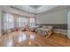 Spacious main bedroom with hardwood floors, large windows, and a tray ceiling at 3365 Preservation Cir, Lilburn, GA 30047