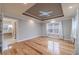 Spacious bedroom with tray ceiling, hardwood floors, and bright window views at 3365 Preservation Cir, Lilburn, GA 30047