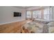 Bright bedroom featuring hardwood floors, large windows, and a wall-mounted television at 3365 Preservation Cir, Lilburn, GA 30047