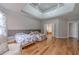 Spacious main bedroom with hardwood floors, chair and plenty of natural light at 3365 Preservation Cir, Lilburn, GA 30047