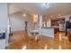 Open breakfast area with hardwood floors, a table with seating, and views of the living spaces at 3365 Preservation Cir, Lilburn, GA 30047