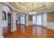 Formal dining room boasting elegant columns, chair railing, hardwood floors and natural light at 3365 Preservation Cir, Lilburn, GA 30047