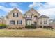 Elegant brick home with manicured lawn, mature landscaping, and beautiful architectural details at 3365 Preservation Cir, Lilburn, GA 30047