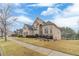 Beautiful home featuring a manicured lawn, mature landscaping, and an inviting entrance, enhancing curb appeal at 3365 Preservation Cir, Lilburn, GA 30047