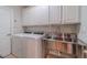 Spacious laundry room featuring modern appliances, stainless steel sink, and ample storage at 3365 Preservation Cir, Lilburn, GA 30047
