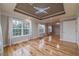 Large living room with lots of light, tray ceilings, and hardwood floors at 3365 Preservation Cir, Lilburn, GA 30047