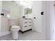 Bright bathroom featuring updated toilet, stylish black and white mosaic flooring, and modern vanity at 5360 Brooke Ridge Dr, Dunwoody, GA 30338