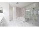 Elegant bathroom features marble tile, a soaking tub, and glass-enclosed shower, creating a spa-like ambiance at 5360 Brooke Ridge Dr, Dunwoody, GA 30338