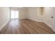 Spacious bedroom with laminated wood flooring, ceiling fan, and bright natural light at 5360 Brooke Ridge Dr, Dunwoody, GA 30338