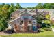 Inviting multi-story exterior showcasing brick accents, a private balcony, lush green landscaping, and a convenient carport at 5360 Brooke Ridge Dr, Dunwoody, GA 30338