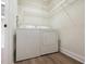 Practical laundry room with a washer, dryer, and wire shelving at 5360 Brooke Ridge Dr, Dunwoody, GA 30338