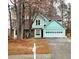 Two-story home featuring a light green exterior, brick details, and a driveway at 1034 Bettina Ct, Mableton, GA 30126