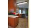 A kitchen featuring wood cabinets, countertop space, black appliances, and an overhanging pot rack at 1034 Bettina Ct, Mableton, GA 30126