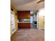 Open kitchen area with wood cabinets, countertops and view into a room with a fireplace at 1034 Bettina Ct, Mableton, GA 30126