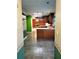 Open kitchen area with wood cabinets and view into a room with a fireplace at 1034 Bettina Ct, Mableton, GA 30126