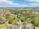 Expansive aerial shot of the neighborhood showcasing the home's setting amidst lush greenery and mature trees at 105 Oakfield Way, Douglasville, GA 30134