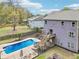 Aerial view of the backyard with pool, deck, patio, and lush landscaping at 105 Oakfield Way, Douglasville, GA 30134
