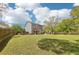 Sprawling backyard featuring a wooden deck, mature trees, and a lush green lawn at 105 Oakfield Way, Douglasville, GA 30134