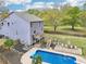 Aerial view of the backyard with pool, deck, patio, and lush landscaping at 105 Oakfield Way, Douglasville, GA 30134