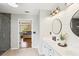 Bathroom featuring a double sink vanity, a shower with glass doors, and an entrance to the bedroom at 105 Oakfield Way, Douglasville, GA 30134