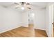 Clean bedroom with wood-look floors and neutral walls, leading to a bathroom at 105 Oakfield Way, Douglasville, GA 30134