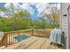 Outdoor wooden deck offering views of the sparkling pool and surrounding backyard at 105 Oakfield Way, Douglasville, GA 30134