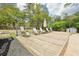 Outdoor wooden deck with seating, perfect for relaxing and enjoying the serene backyard at 105 Oakfield Way, Douglasville, GA 30134